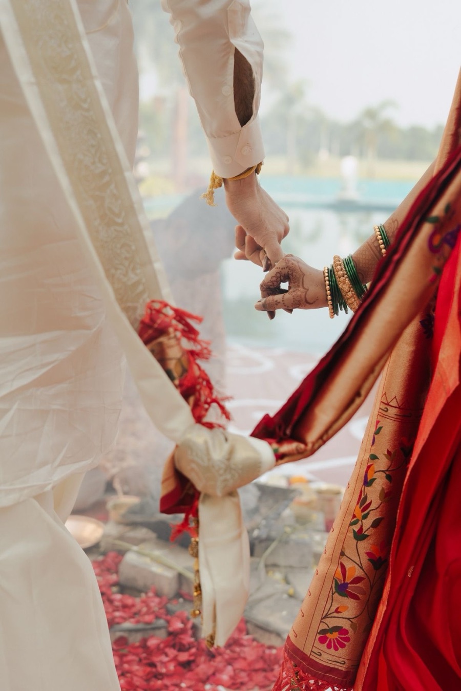 A couple's hands joined during a traditional Indian wedding ceremony